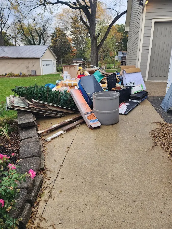 Dumpster being loaded with debris for Estate Cleanout Dumpster Rental in Greenbriar